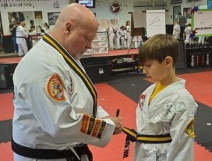 Kace receiving a new belt